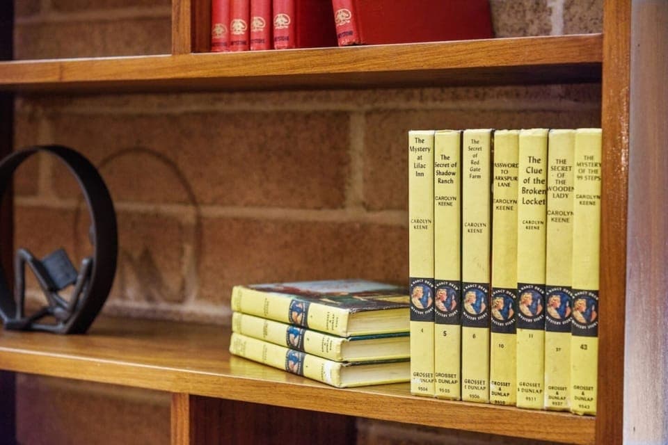 Collection of books from the 1960's and 1970's, including cookbooks, children's books, fiction, and encyclopedias.