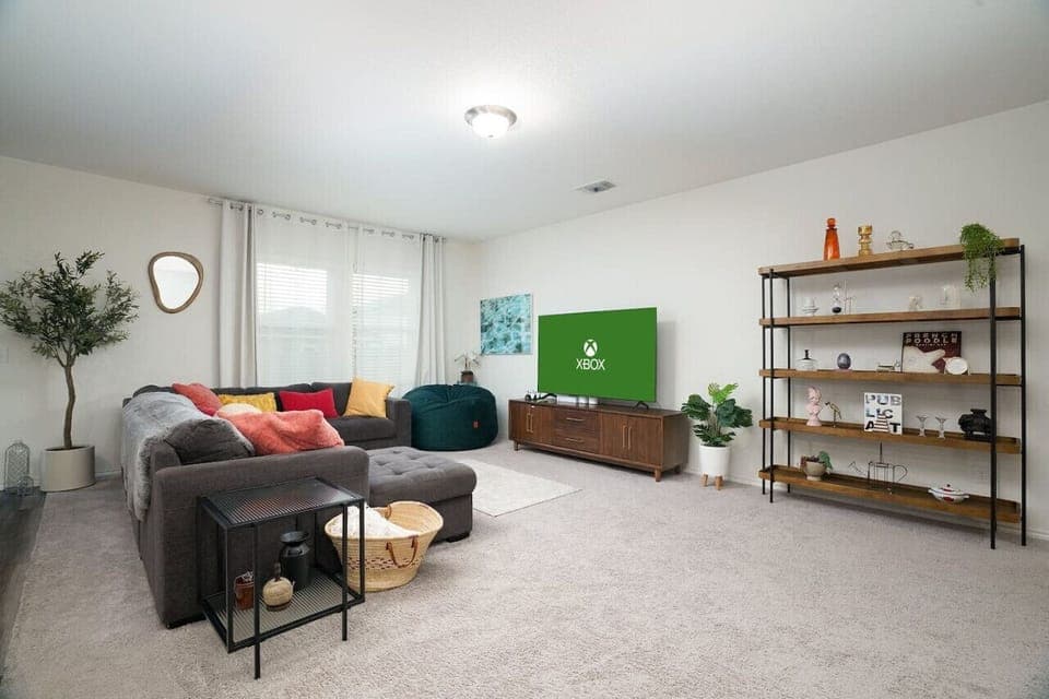 Relax in style in this spacious and cozy living room! Featuring a large TV with Xbox for entertainment, plush seating, and modern décor—perfect for movie nights or unwinding after a long day.