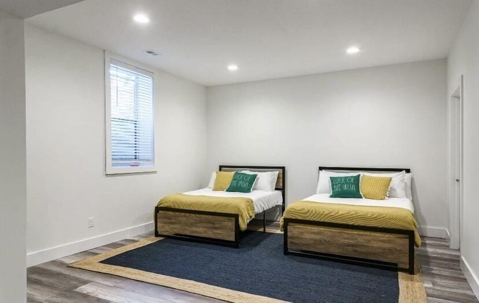 Open bedroom in the basement’s with 2 double beds and access to full bathroom