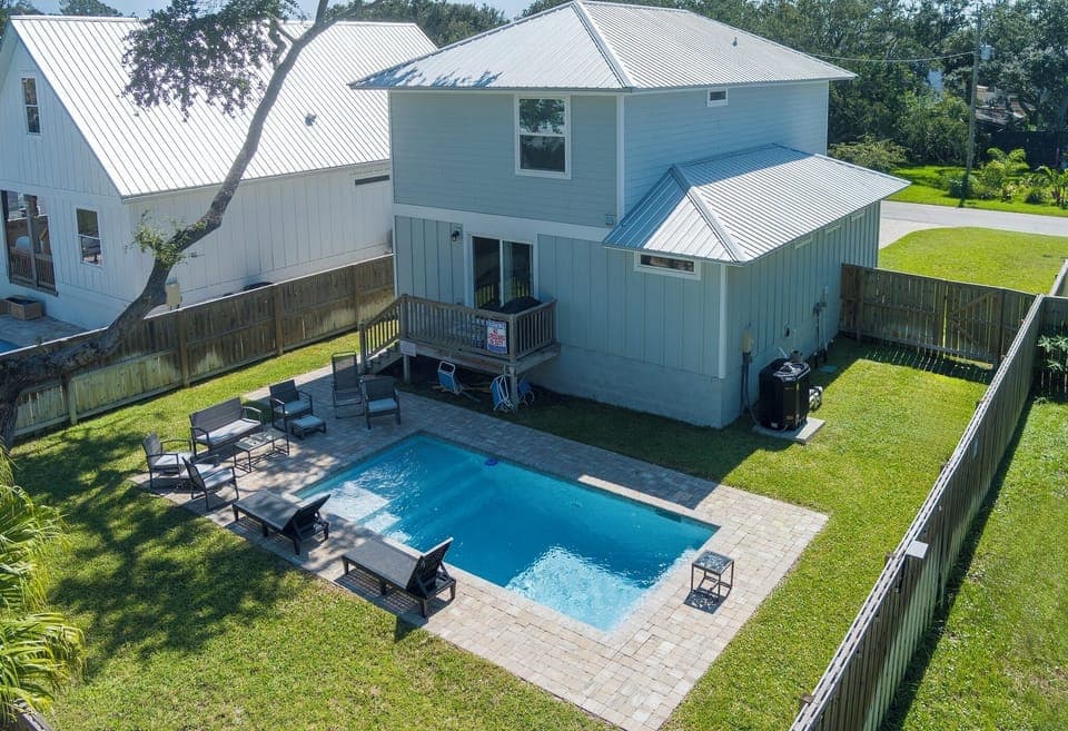 Enjoy your own fenced-in oasis with a sparkling private pool, sunny lounge seating, and plenty of space to relax—perfect for laid-back afternoons and unforgettable vacation vibes.