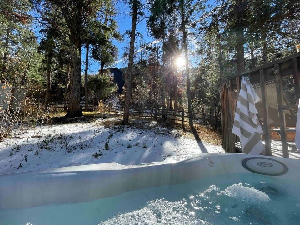 Views of the forest and mountains await as you soak in the hot tub.