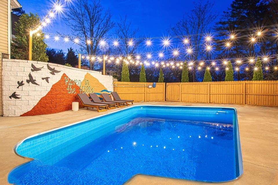 Envision pure relaxation by our 25,000 sq. ft. in-ground pool, surrounded by enchanting outdoor lighting. Share this delightful space with friends and family; they'll cherish the experience.