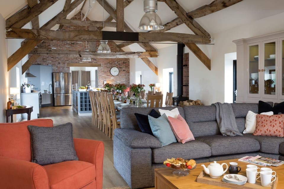 Spacious, open-plan sitting, dining and kitchen area on the first floor with exposed beams