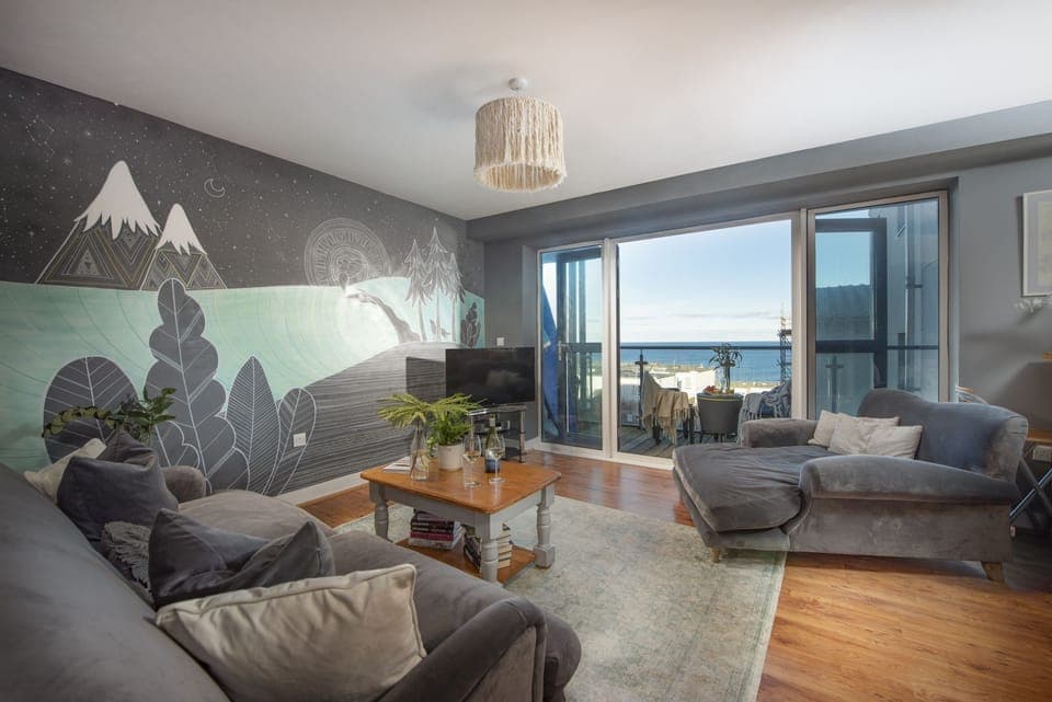 Fully furnished living room with hand painted artwork on the wall - Bathsheba, Ocean 1