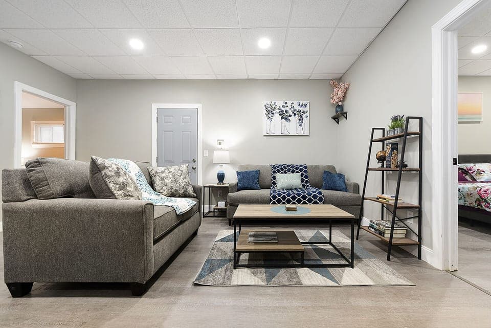 The living room features cozy furniture, ample natural light, and modern decor.