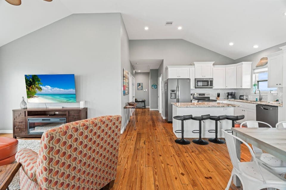 As you enter the home take in the view of the living room, kitchen and dining space.