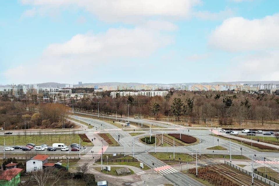 Another aerial perspective highlighting a highway interchange, green areas, and a well-planned urban landscape.







