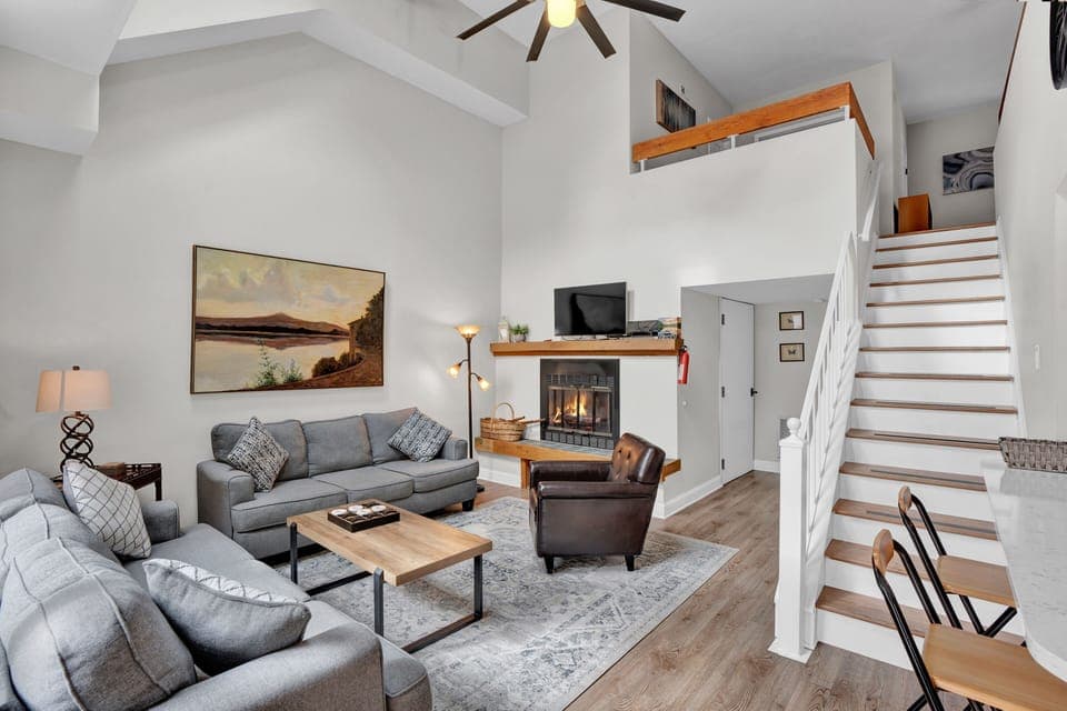 Living room with vaulted ceiling and fireplace