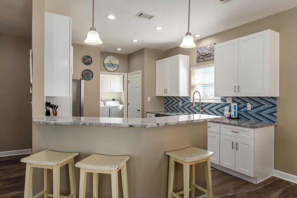 Your bright, open kitchen features granite counters, modern appliances, and a breakfast bar perfect for morning coffee conversations.