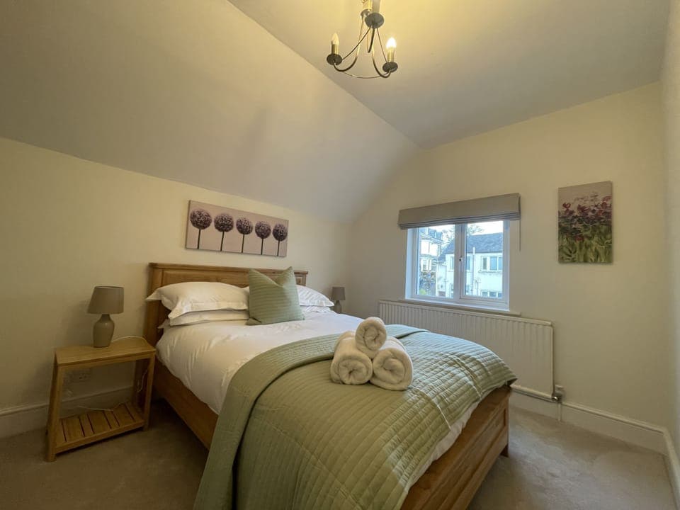 This bedroom is furnished with double bed, wardrobe and bedside tables