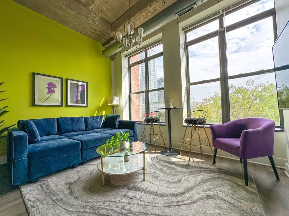 Spacious living room with a lot of natural light and large windows.
