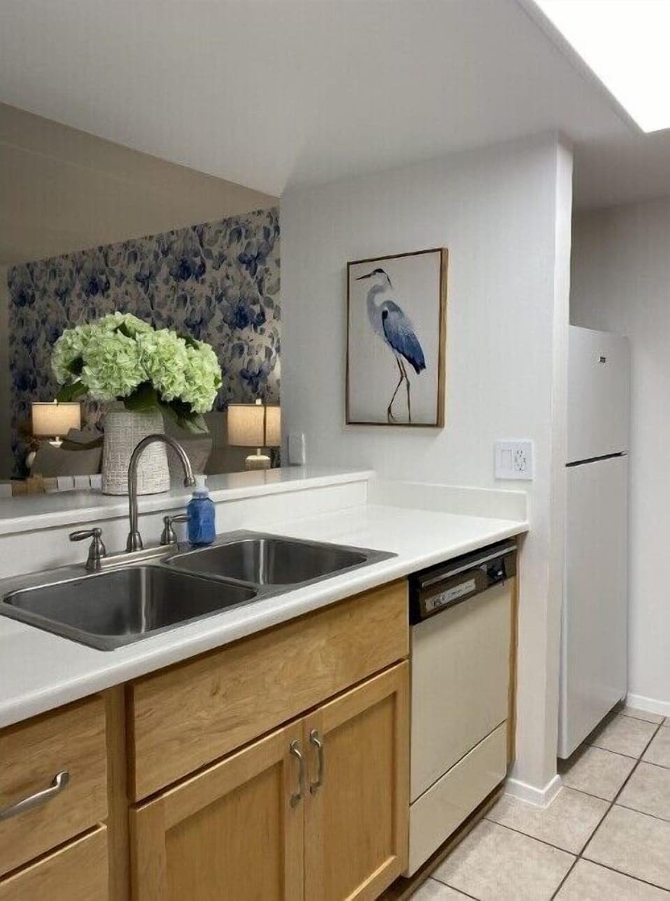 Fridge, dishwasher, and full sink. 