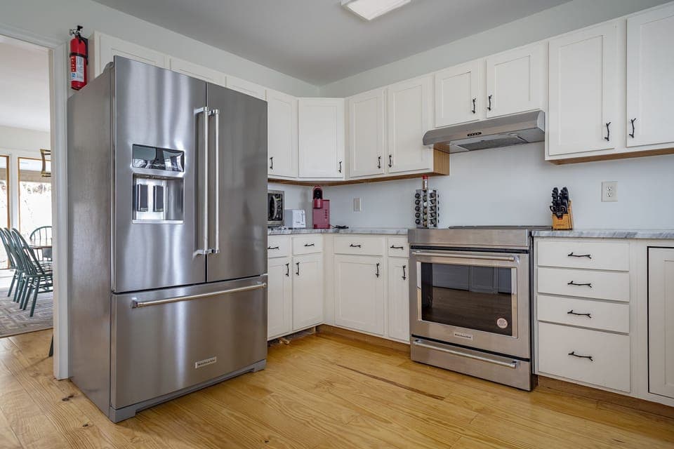 Kitchen with stainless appliances, dishwasher & Keurig coffeemaker.