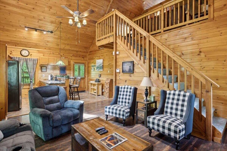 Warm wood tones, inviting seating, and a view of the lush outdoors await your escape!