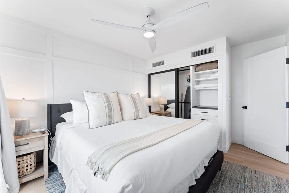 The first bedroom includes a king-size bed with fresh, clean bedding.