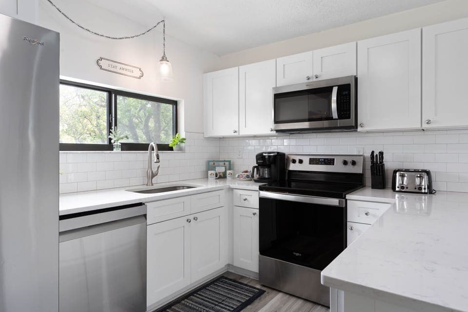 In this bright, polished kitchen, mornings begin with pancakes on the stove, coffee brewing, and sunlight slipping through the window. It is where sleepy conversations turn into family plans for the beach, and simple breakfasts become part of the memory.
