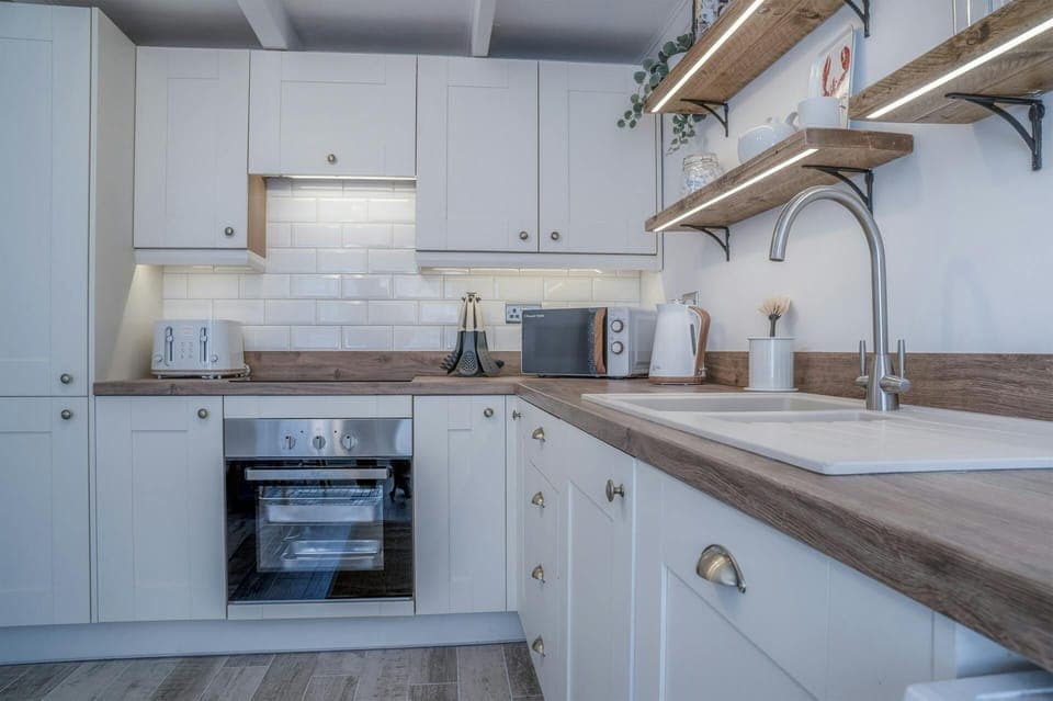 Mount Gernos kitchen showing an integrated cooker and matching kitchen appliances