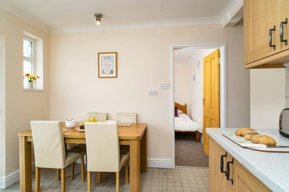 Kitchen and dining area with table and four chairs