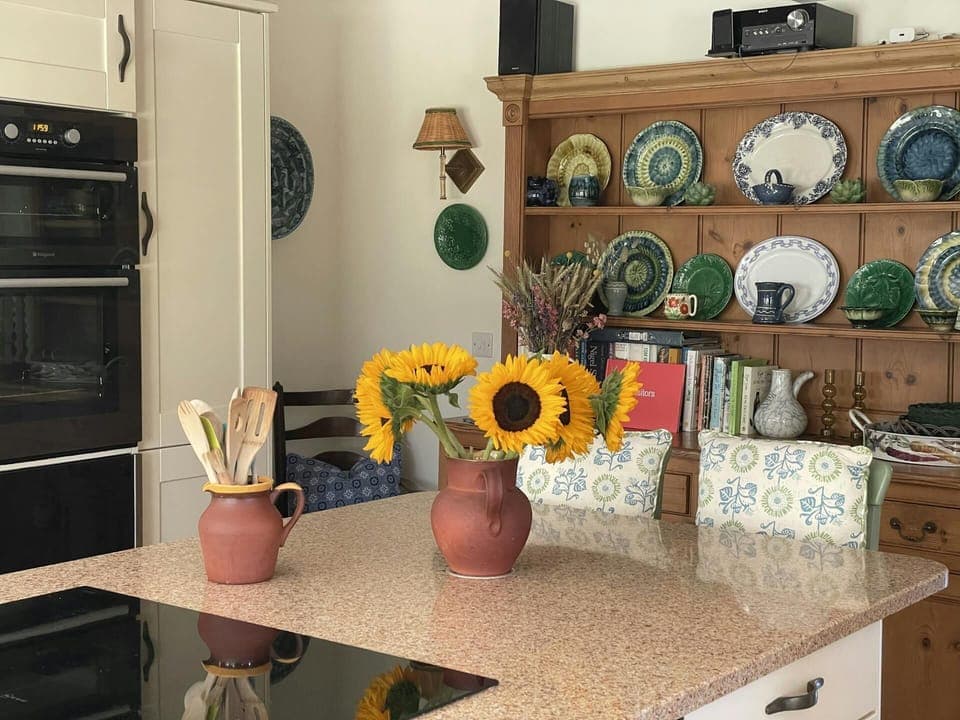Kitchen with kitchen island, built in ovens, welsh dresser with crockery