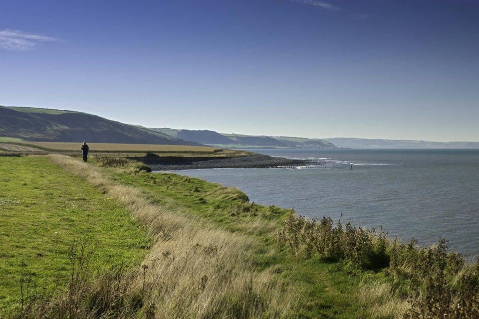 Person walking along the coast path near Llanrhystud