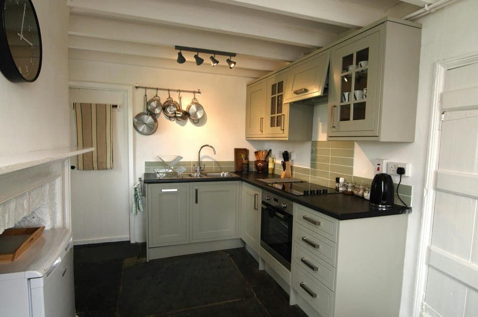 Kitchen, built-in cooker and hob, utensils, kettle and fridge