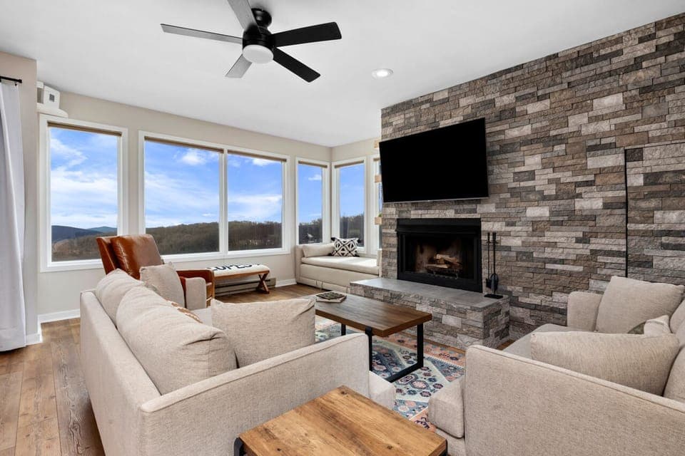 Large living room with plenty of seating, 65" Roku HDTV, and cozy fireplace.
