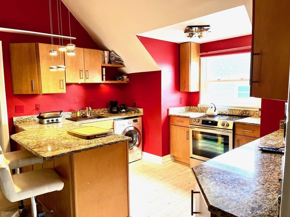 Full designer kitchen with granite countertops and breakfast (dining) bar