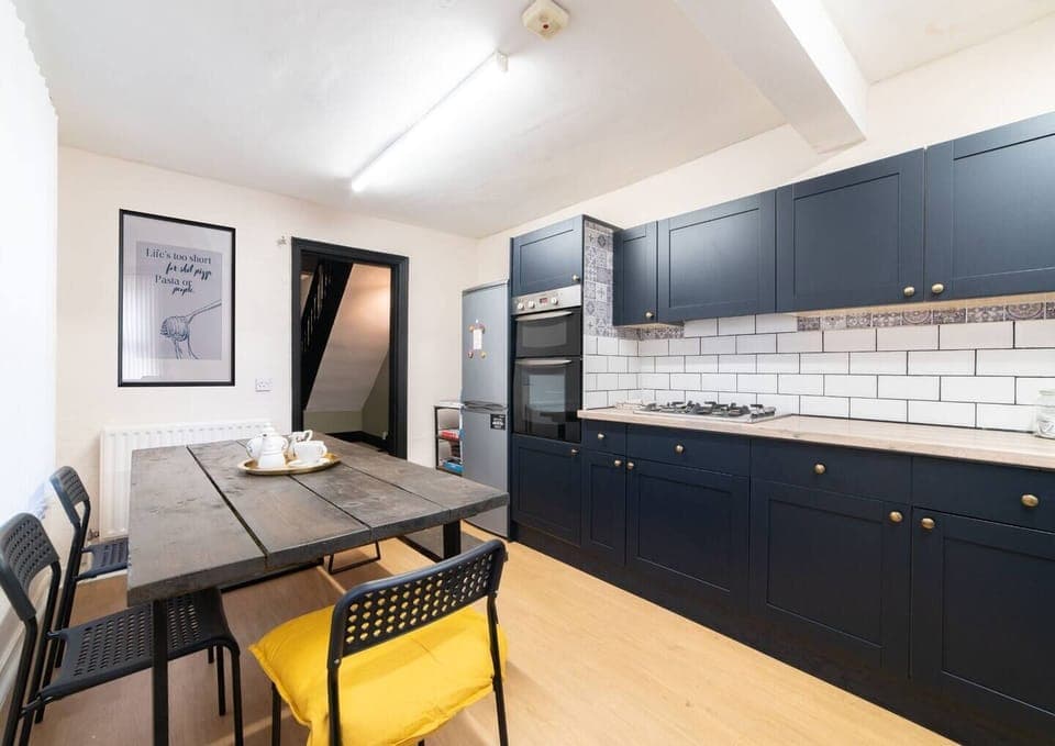 Dining area within the kitchen featuring:

- Oven
- Stove
- Washer
- Microwave
- Toaster
- Electric kettle
- Iron and ironing board