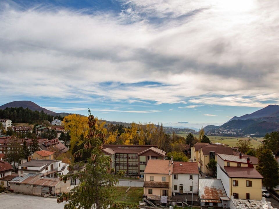 Cloud, Sky, Building, Mountain, Ecoregion, Tree, House, Plant, Highland, Window