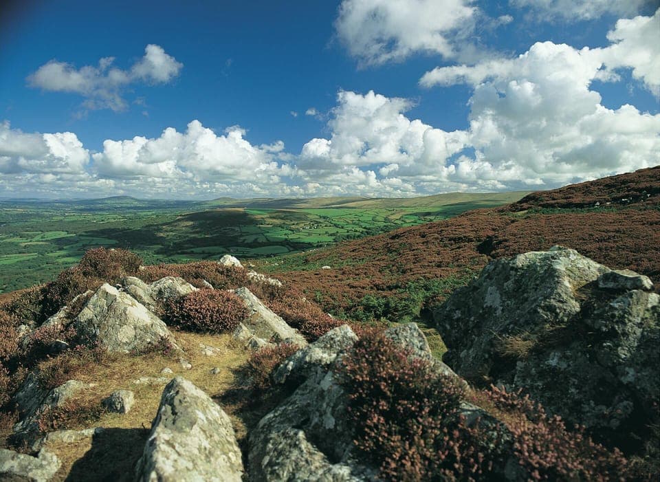 Top of Carn Ingli hill in Newport Pembrokeshire with countryside green field views below