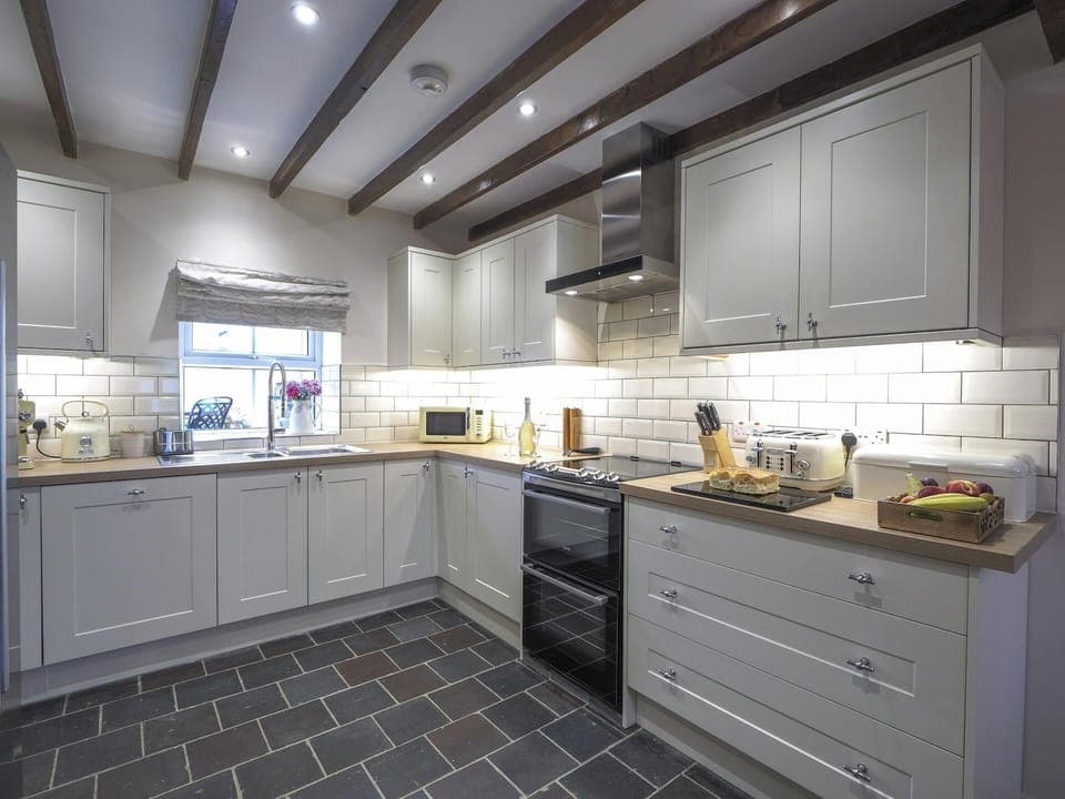 Tiled kitchen floor and beamed ceiling