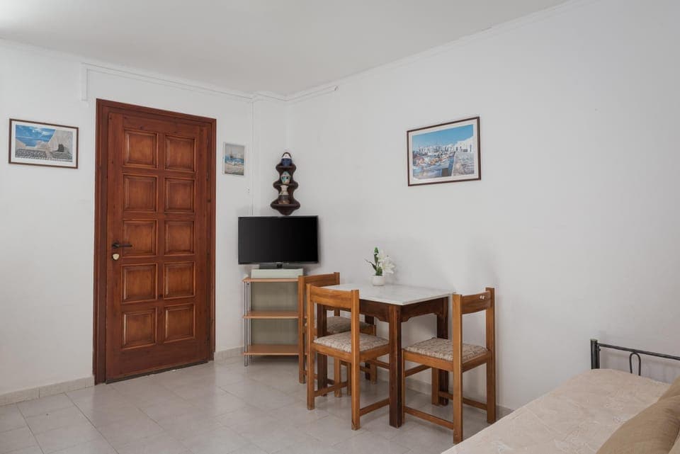 Standard Apartment | Living area | 25-inch flat-screen TV with cable channels