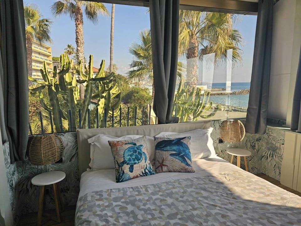 Deluxe Room, Balcony, Sea View | Minibar, in-room safe, desk, free WiFi