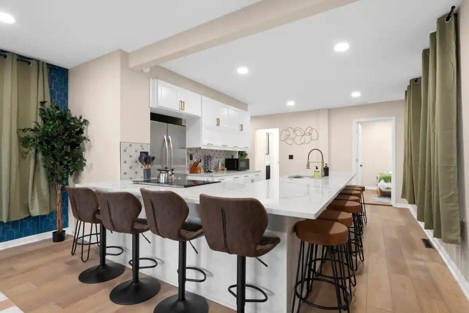 Fully stocked kitchen with Keurig, cookware, and stainless steel appliances