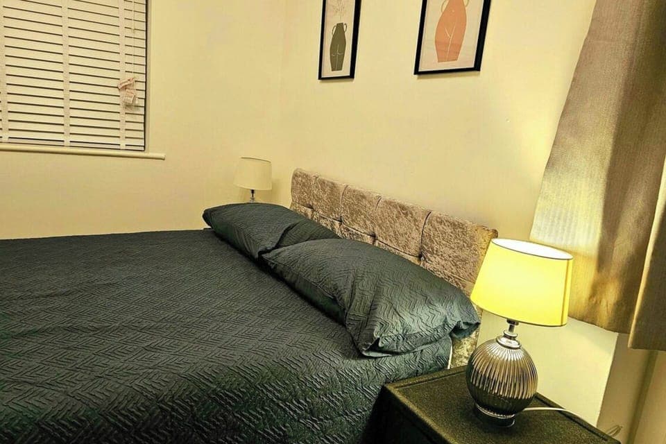 This comfortable room offers a comfortable bed with soft linens and warm lighting, creating a peaceful atmosphere. 