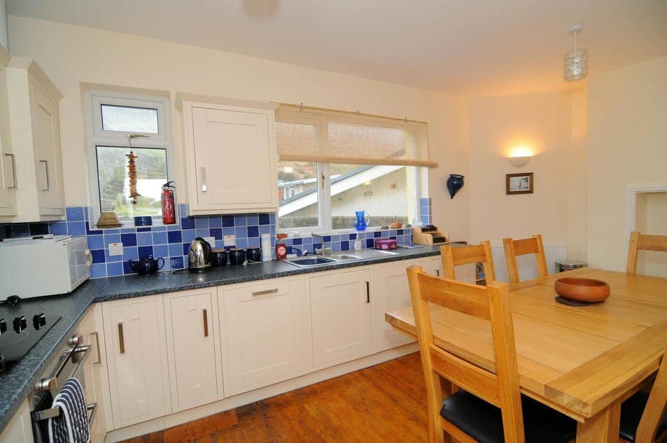 Fitted kitchen/diner: oven and hob, microwave and kettle: Dining table with six chairs