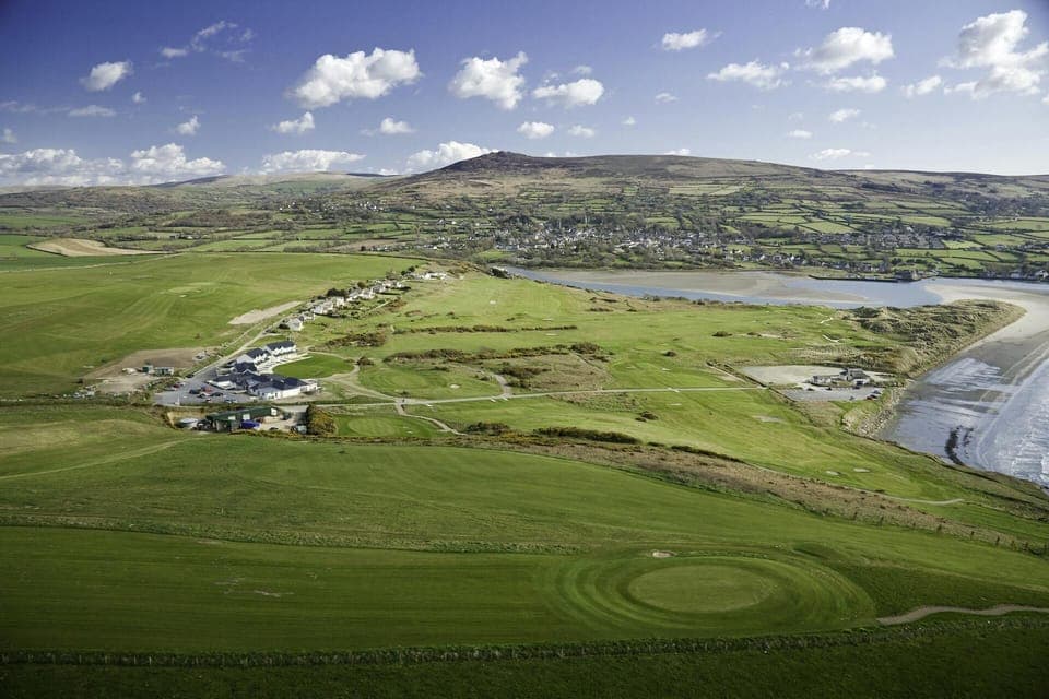 Golf links with Newport Estuary and town beyond, beach to the right