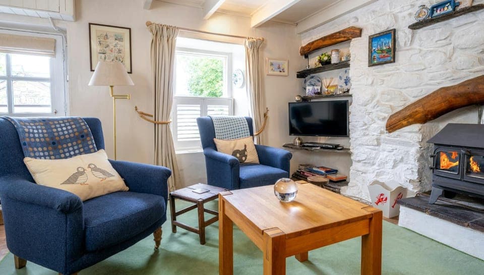 Two arm chairs, coffee table and electric woodburner effect fire