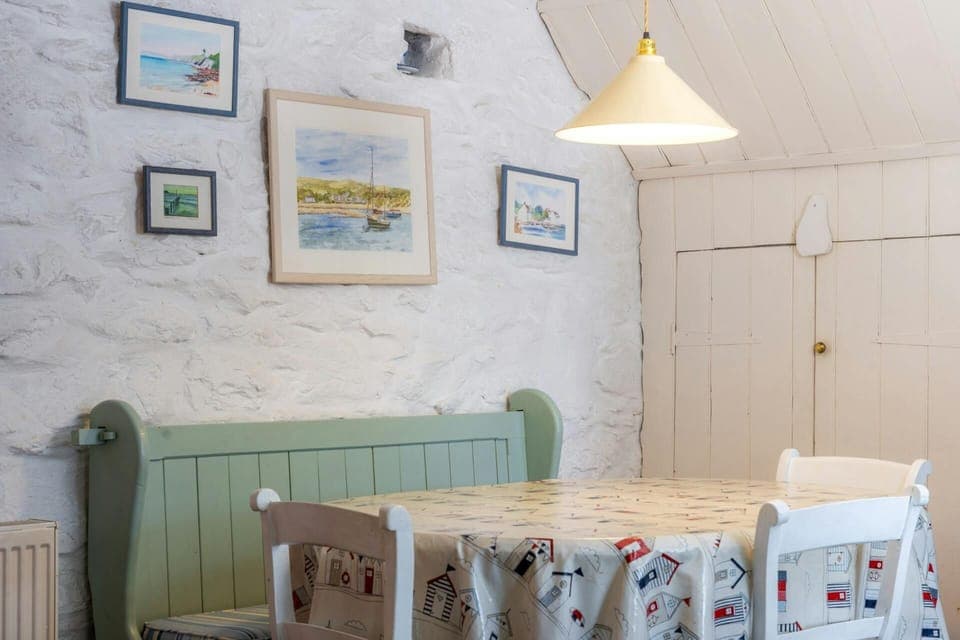 Dining table with 3 chairs and wooden settle with cushions