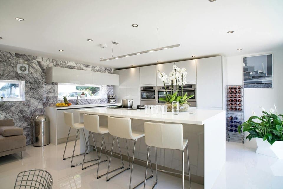 Oven, combination microwave, counter seating for 4, 3-seater sofa and wine rack