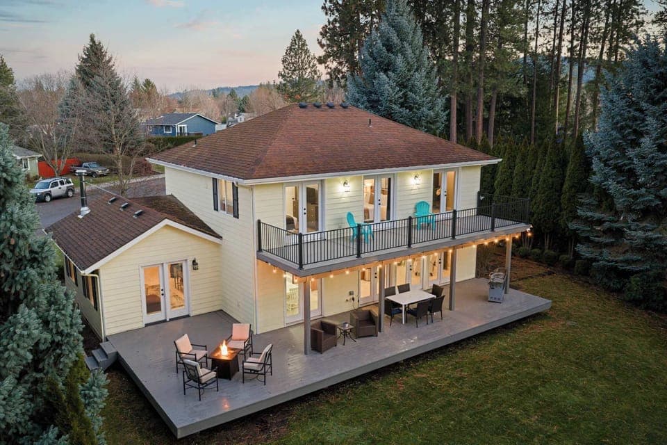 Private backyard retreat with expansive covered decks, fire pit, and forest views — designed for gathering, relaxing, and long summer nights.