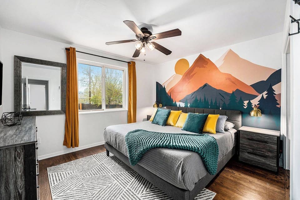 The master bedroom features a king-sized bed, modern side tables with lamps and soft linens.