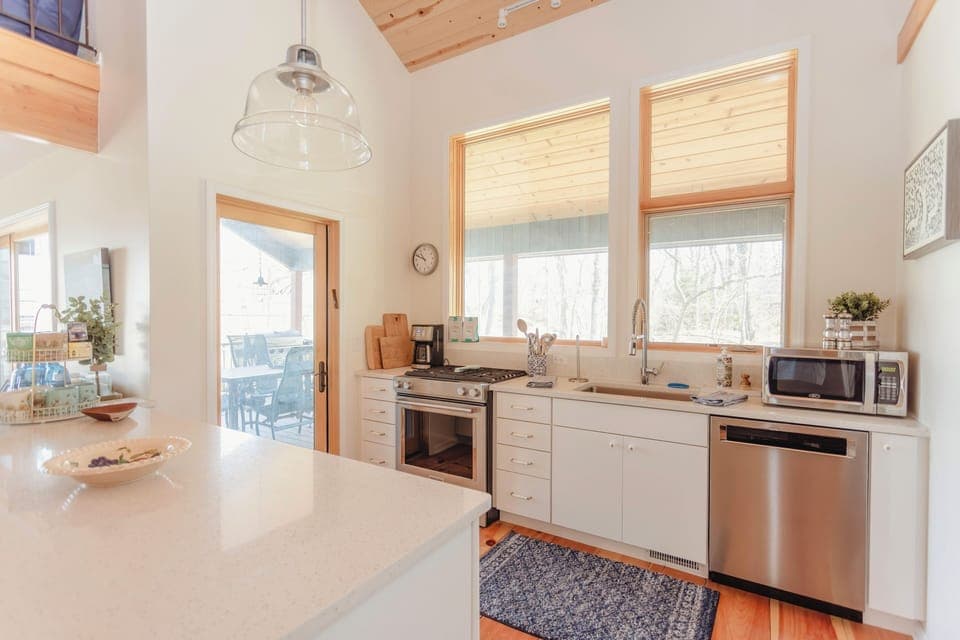 Kitchen area with views of screened porch and backyard