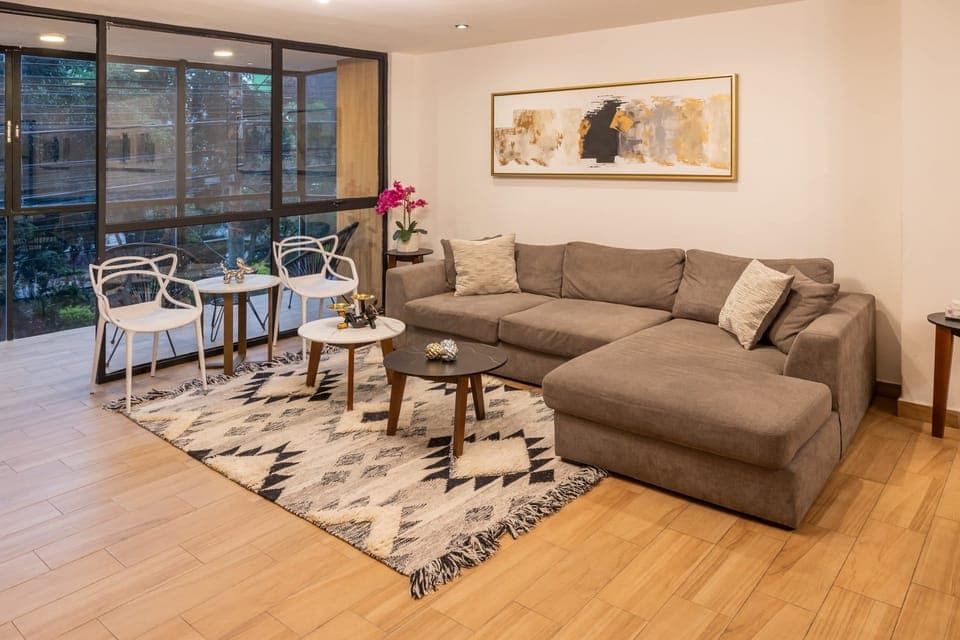 Relax in the living room with plenty of natural light, and direct access to the balcony.
