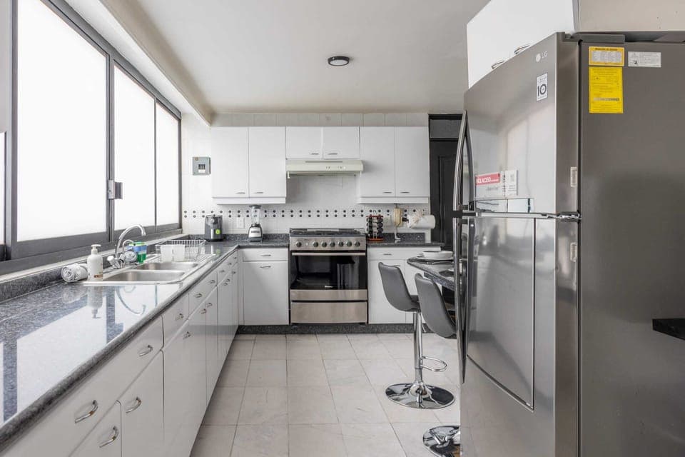 Modern kitchen with a cozy breakfast nook, perfect for casual meals or morning coffee.