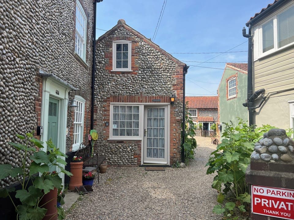 Triple aspect flint cottage formerly a “cart shed /gig house”