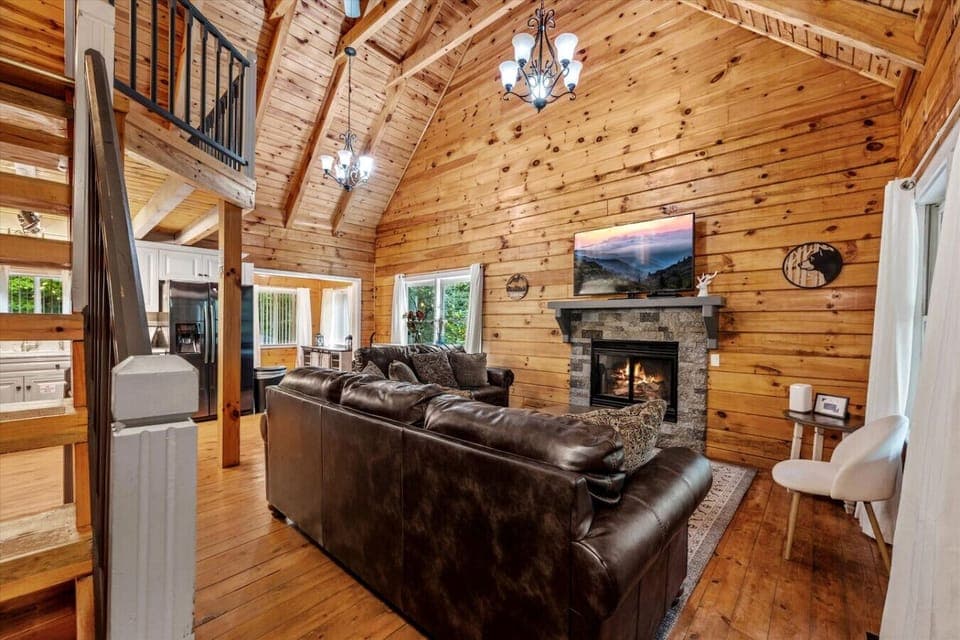 The beautiful living room includes plenty of comfortable seating, a large Smart TV, and a (seasonal) gas fireplace.