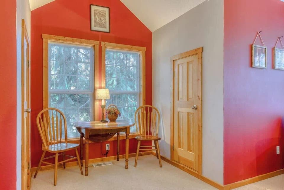 Unwind in the private seating area of the primary bedroom, a serene space with views and natural lighting.