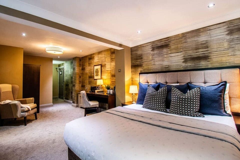 Large suite with king bed, kitchenette, and dedicated workspace