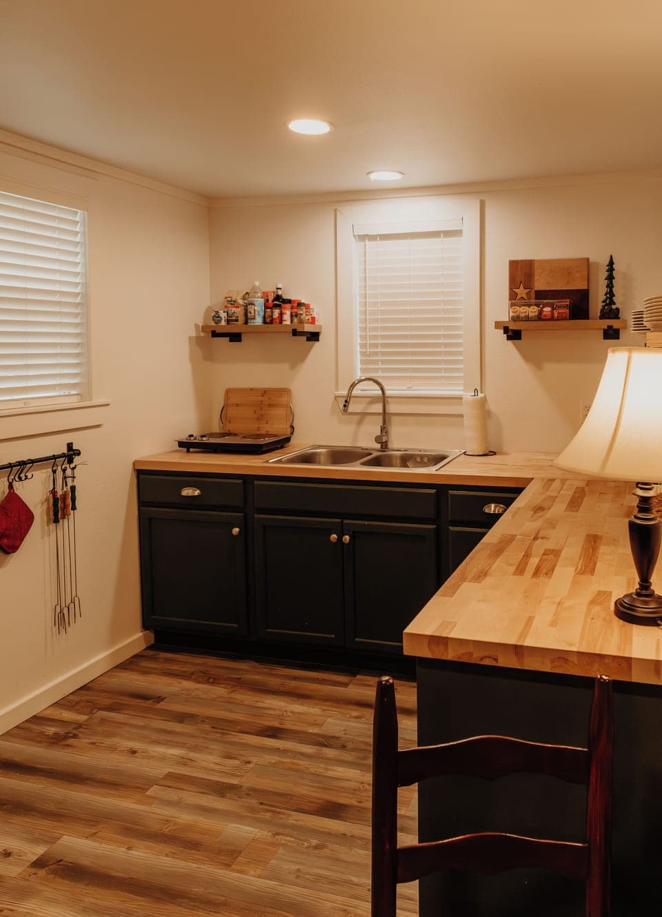 A view of the kitchen, equipped with a mini fridge and electric 2-burner stove